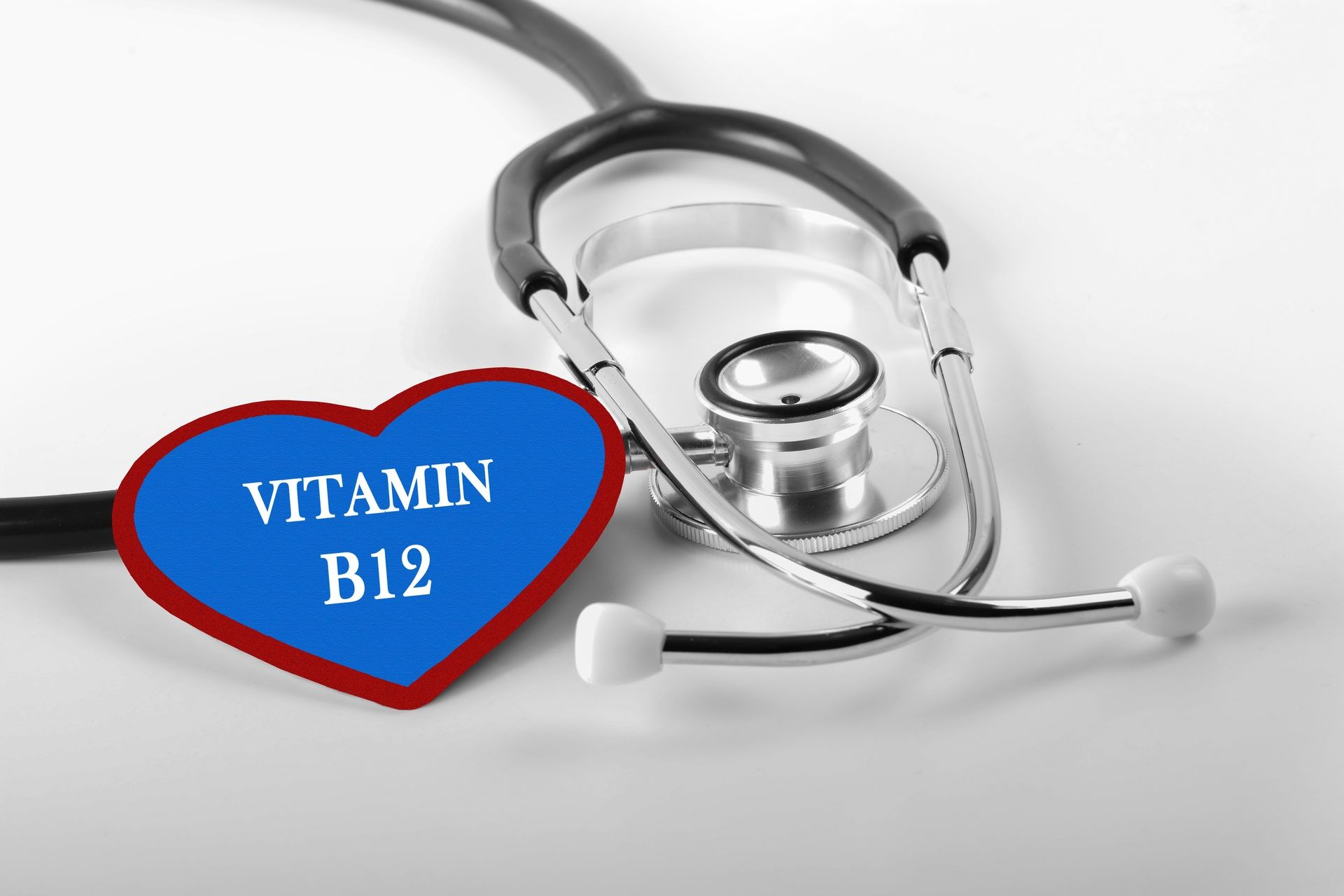 Black and white Stethoscope and red love with medical conceptual text "VITAMIN B12"