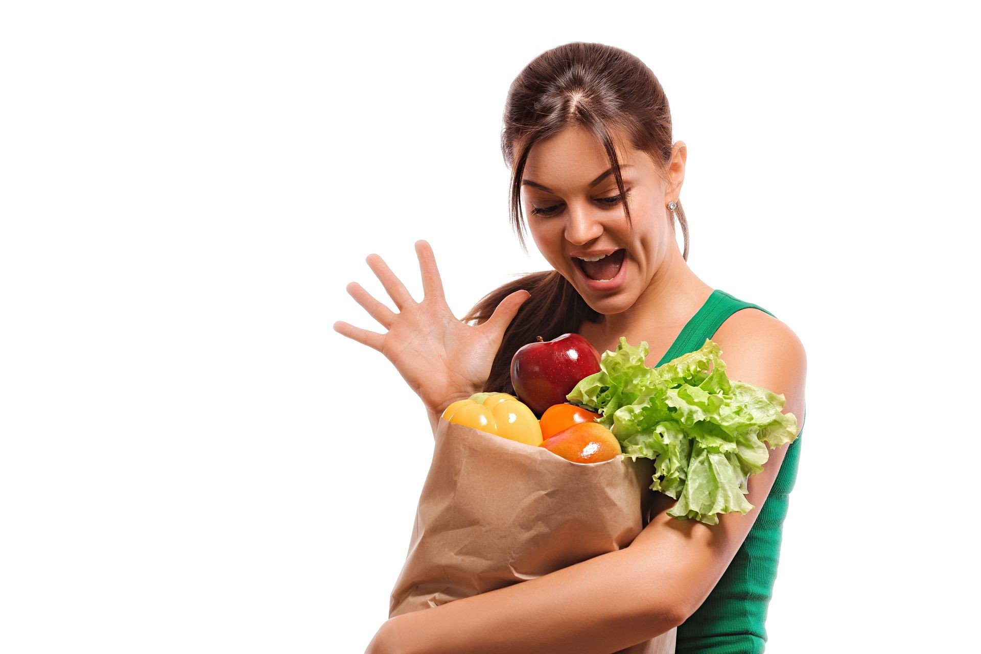 Happy young girl with a bag of fruit and vegetables enjoys a healthy diet. woman holding shopping paper bag with organic fresh food isolated on white background. 